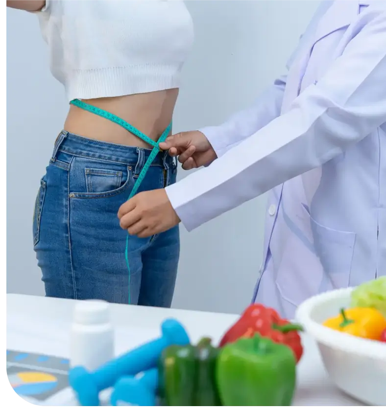 A doctor measures a patient's waist circumference.